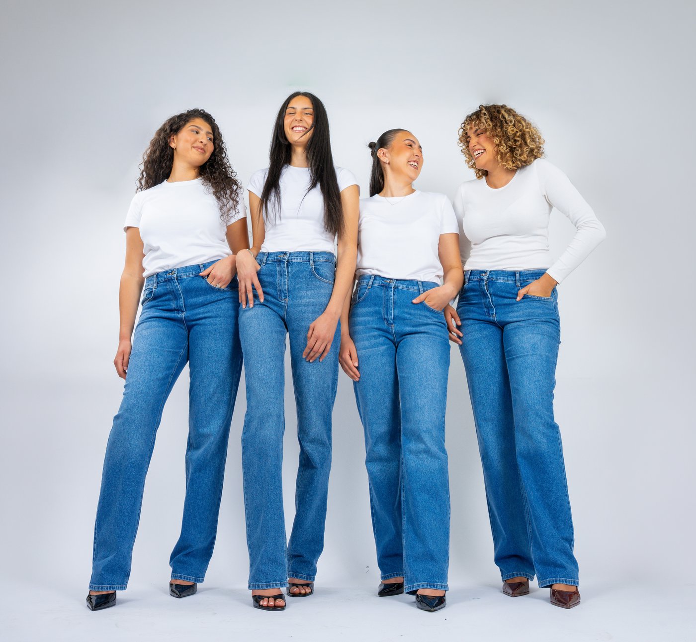 Quatre femmes Tall qui rient ensemble, en jean TALJEAN